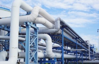 Closeup of industrial pipelines around a factor on a sunny day A closeup of industrial pipelines around a factor on a sunny day